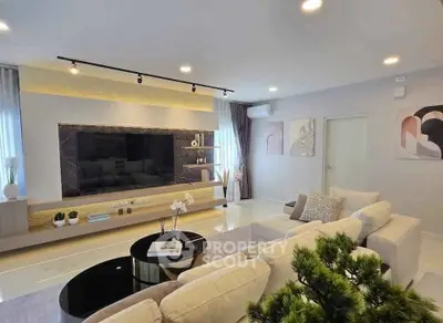 Luxurious modern living room with elegant decor and large flat-screen TV, perfect for relaxation and entertainment.