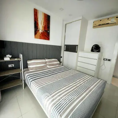Modern bedroom with stylish decor and air conditioning in a contemporary apartment.