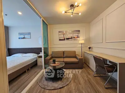 Modern studio apartment with stylish decor, featuring a cozy living area and a comfortable bedroom.