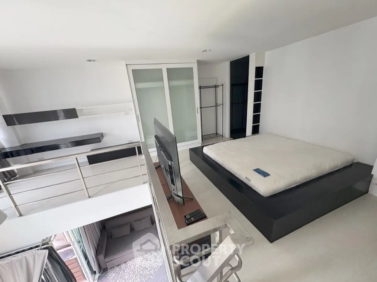 Modern loft-style bedroom with sleek design and open layout