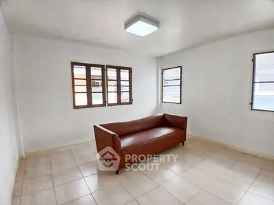 Spacious minimalist living room with natural light and modern sofa