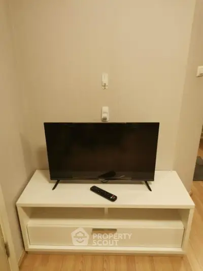 Modern living room setup with sleek TV stand and flat-screen television.