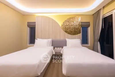 Modern twin bedroom with stylish decor and ambient lighting