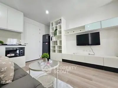 Modern living room with sleek furniture and built-in shelving, ideal for urban living.