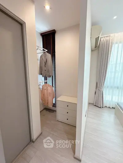 Modern bedroom with walk-in closet and natural light