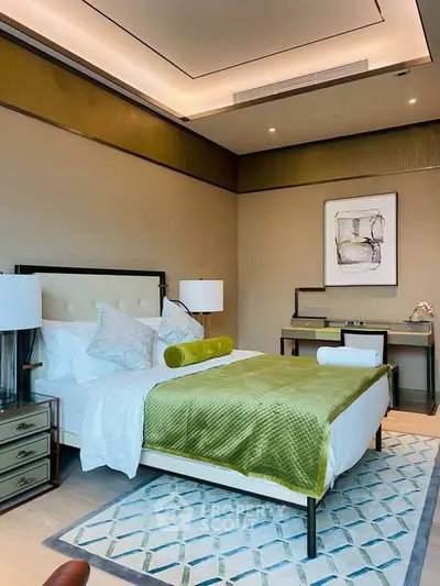 Luxurious bedroom with elegant decor and modern furnishings, featuring a plush bed and stylish artwork.