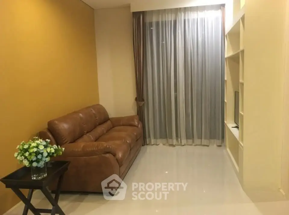 Cozy living room with leather sofa and elegant curtains in modern apartment.
