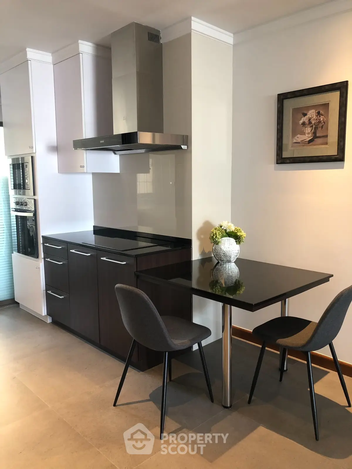 Modern kitchen with sleek cabinetry and cozy dining area