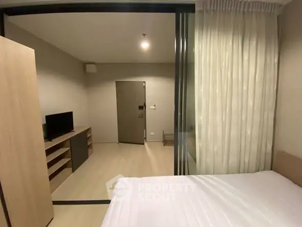 Modern bedroom with sliding glass doors and cozy interior design