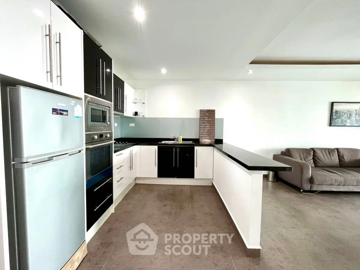 Modern open-layout kitchen with sleek appliances and spacious living area.