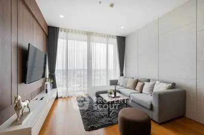 Modern living room with sleek design, large windows, and cozy seating area.