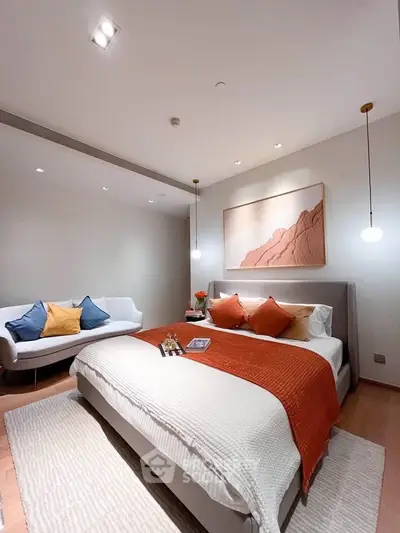 Luxurious bedroom with modern decor and cozy ambiance, featuring stylish lighting and elegant furnishings.