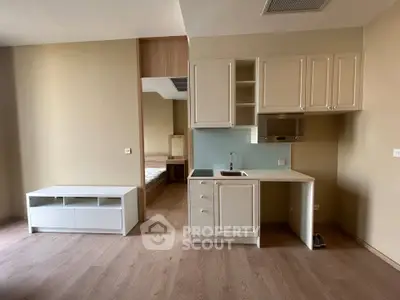 Modern compact kitchen with sleek cabinetry and open layout in a stylish apartment.