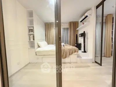 Modern bedroom with sleek design, featuring built-in shelves and a wall-mounted TV.