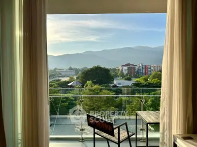 Stunning balcony view with mountains and cityscape, perfect for relaxation and enjoying nature.