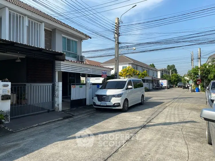 Charming suburban street with modern homes and parked vehicles, ideal for family living.