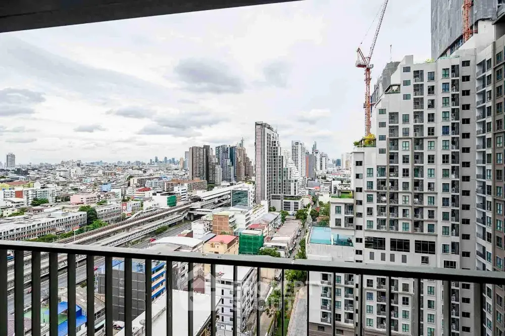 Stunning cityscape view from high-rise balcony with modern architecture and urban skyline.