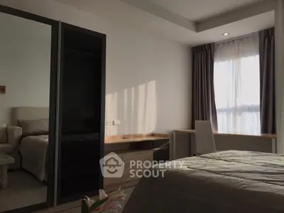Modern bedroom with large window and sleek furniture design