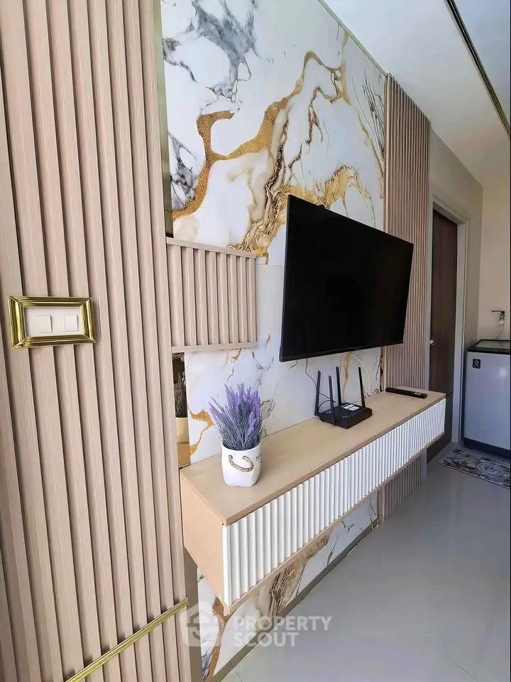Stylish modern living room with marble accent wall and mounted TV
