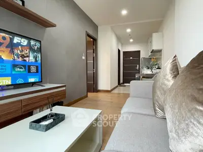 Modern living room with sleek furniture and entertainment setup in a stylish apartment.