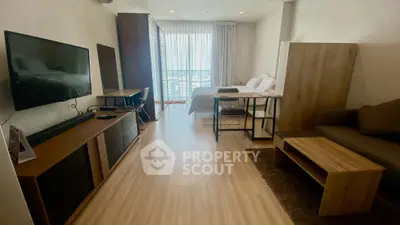 Modern studio apartment with wooden flooring and natural light