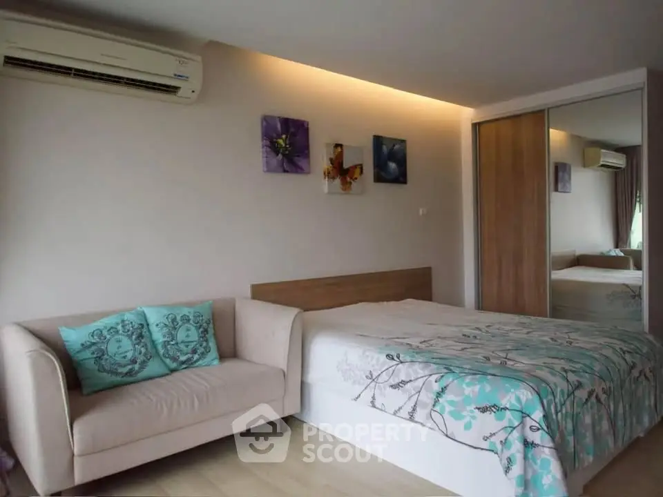 Cozy bedroom with modern decor and mirrored wardrobe