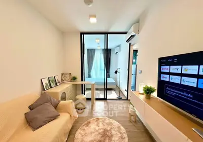 Modern living room with cozy sofa, stylish decor, and smart TV in a bright apartment.
