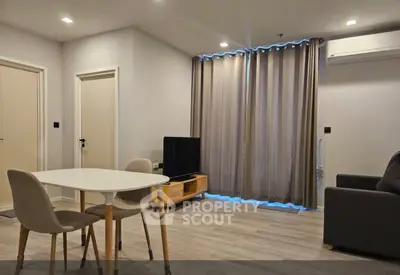 Modern living room with dining area, featuring sleek furniture and ambient lighting.