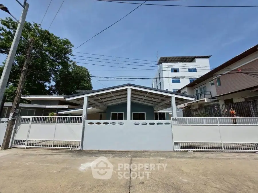 Charming single-story home with modern facade and spacious driveway in a serene neighborhood.