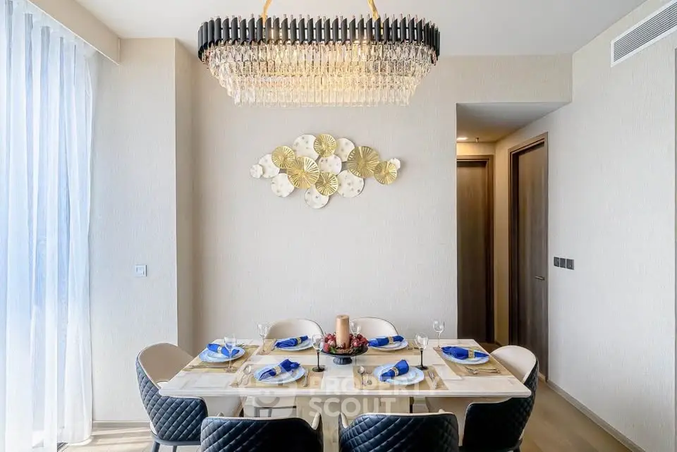 Elegant dining room with modern chandelier and stylish decor, perfect for entertaining guests.