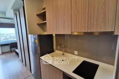 Modern kitchen with sleek cabinetry and built-in appliances in a stylish apartment.