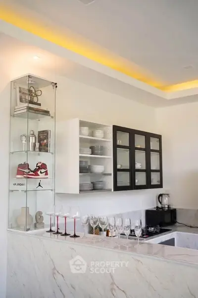 Modern kitchen with sleek marble countertops and stylish glass cabinets
