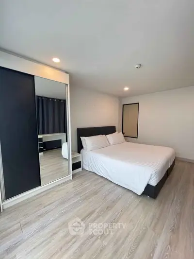 Modern bedroom with sleek design and ample natural light