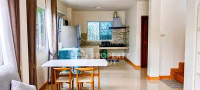 Charming open-layout kitchen and dining area with modern appliances and natural light.
