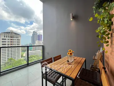 Chic urban balcony with stunning city view, perfect for relaxation and entertaining.
