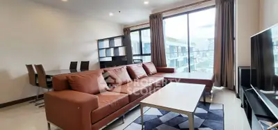 Spacious modern living room with large windows and city view