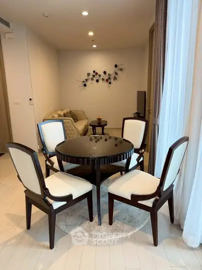 Elegant dining area with round table and stylish chairs in modern apartment
