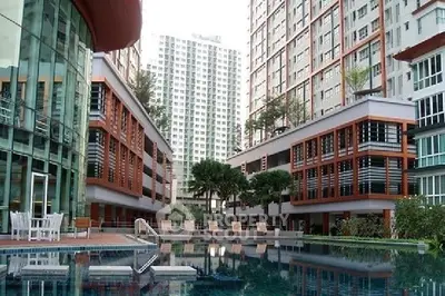 Luxurious residential complex with modern architecture and inviting swimming pool.