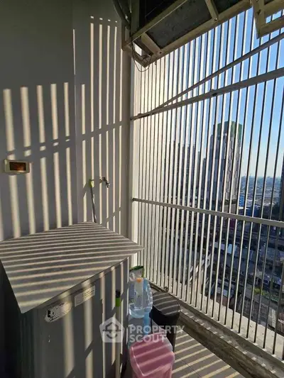 High-rise balcony with city view and utility area, perfect for urban living.