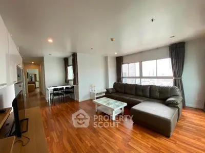 Spacious living room with modern furniture and city view, perfect for relaxation and entertainment.