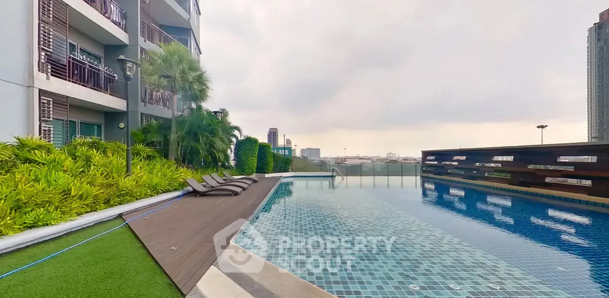 Luxurious rooftop pool with city skyline view in modern apartment complex