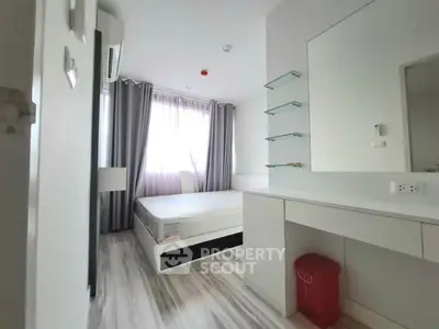 Modern minimalist bedroom with sleek design and ample natural light
