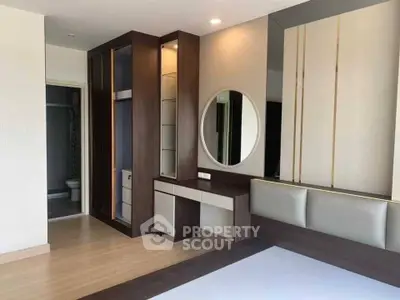 Modern bedroom with built-in wardrobe and stylish vanity area