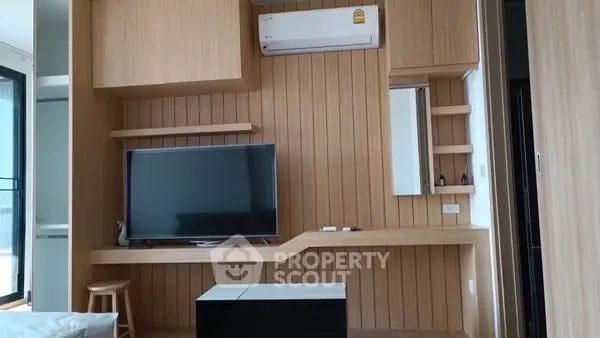 Modern living room with wooden paneling and flat-screen TV