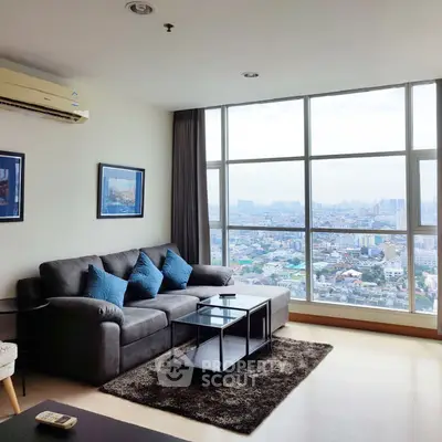 Spacious living room with stunning city view and modern furnishings.