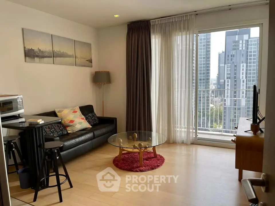 Modern living room with city view, featuring stylish decor and natural light.