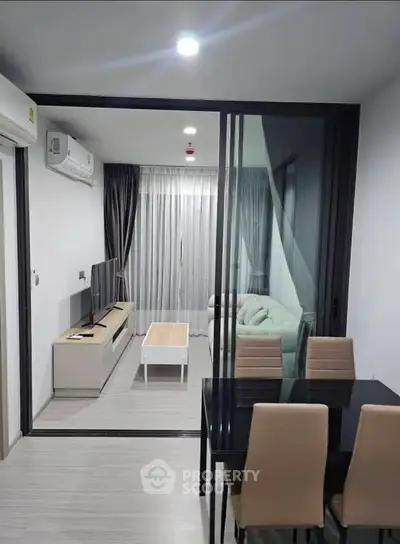 Modern living room with sleek furniture and glass partition in stylish apartment