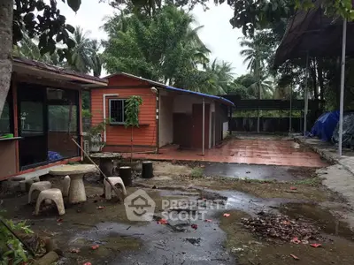 Charming rustic property with outdoor seating and lush greenery, perfect for nature lovers.