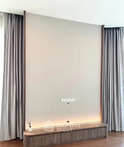 Modern minimalist living room with elegant wood paneling and ambient lighting