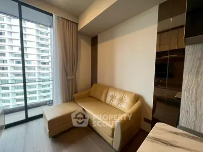 Modern living room with beige sofa and large window overlooking cityscape